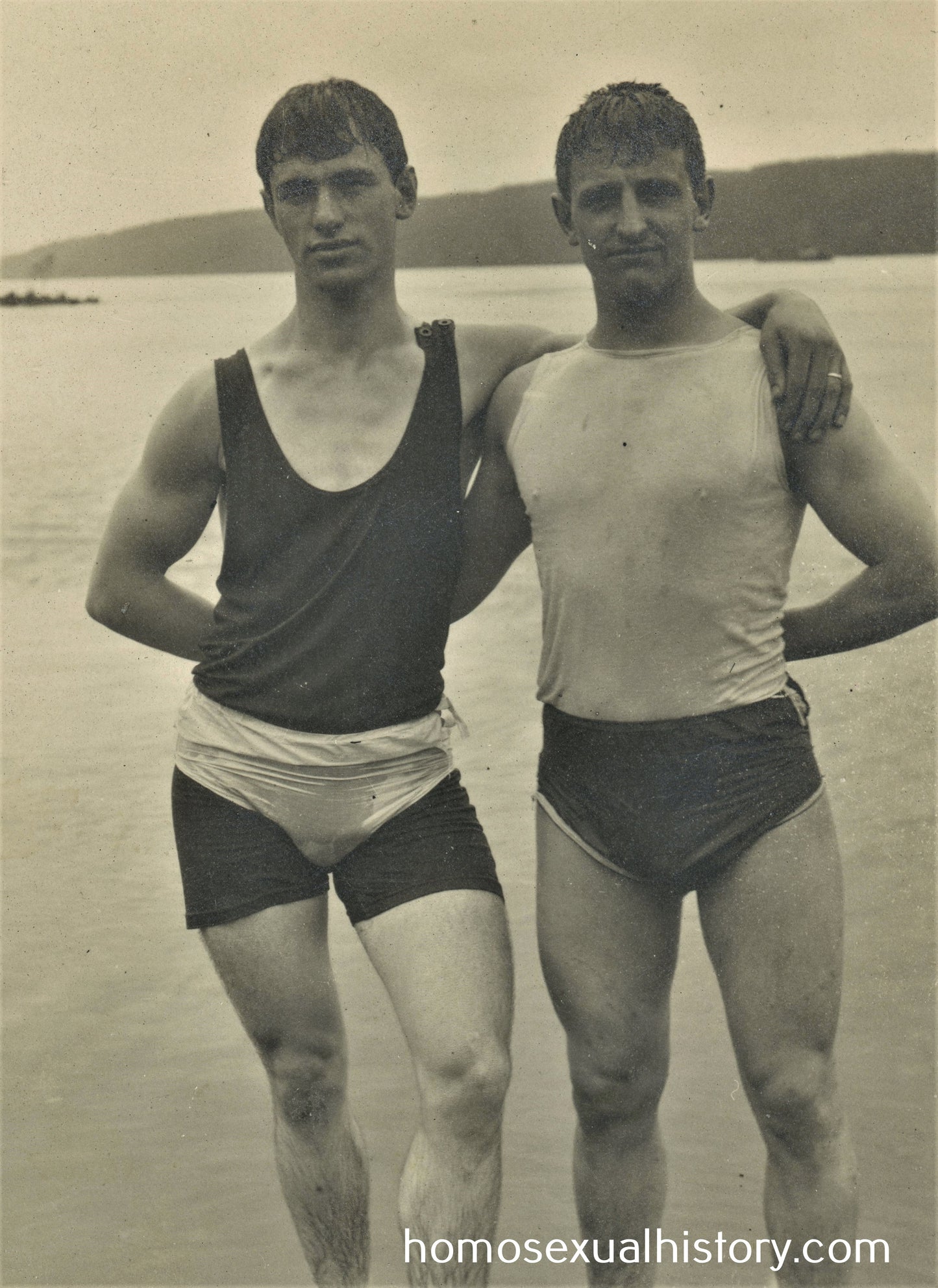 Germany 1920s. Two affectionate men bathing in lake. Swimming costume. Arm in arm.