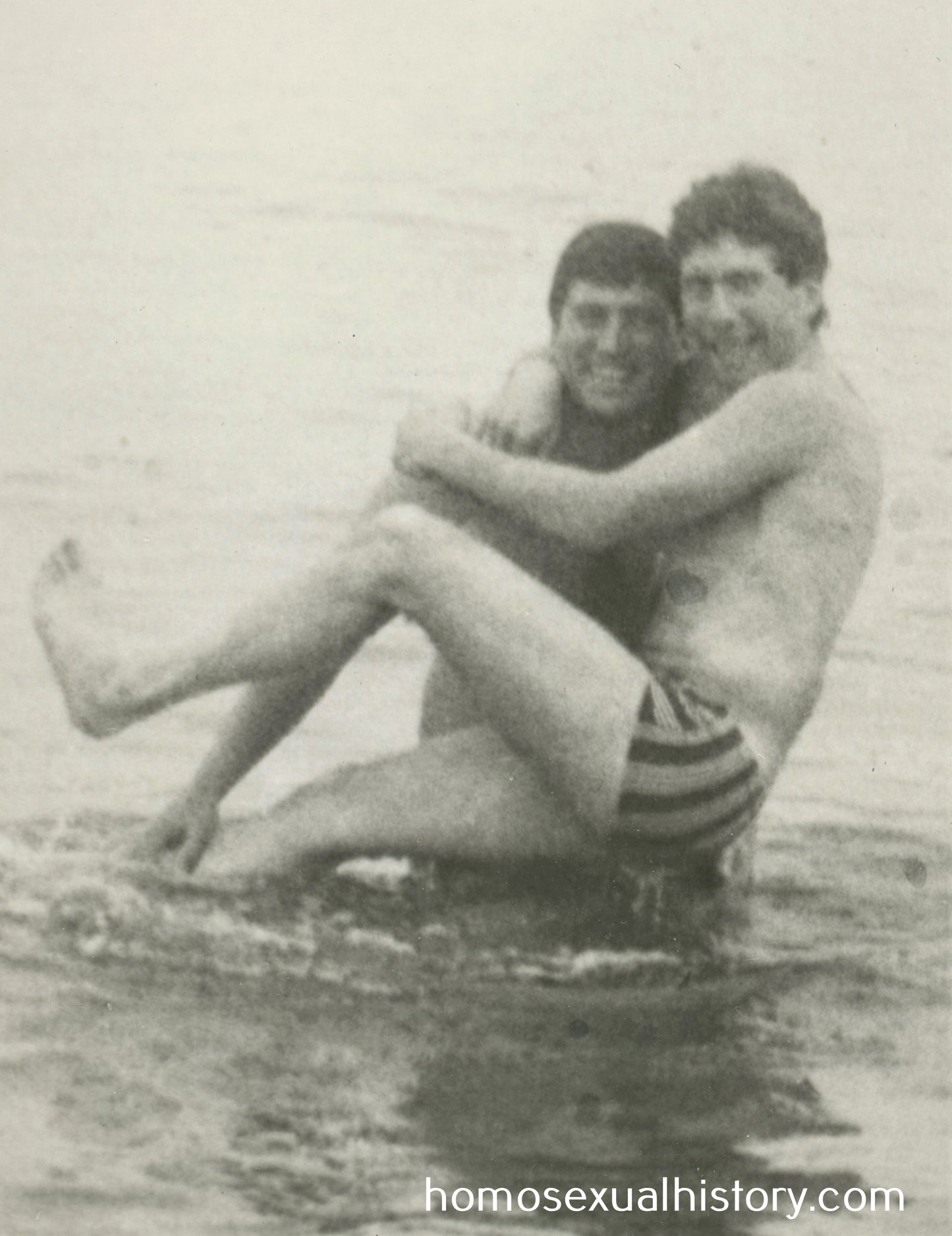 Bulgaria 1950s. Two men at seaside. One carrying the other