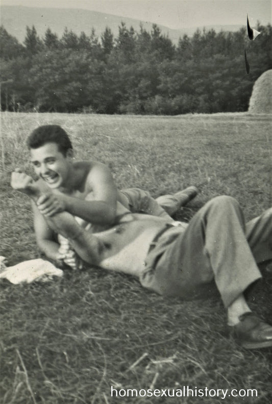 Bulgaria 1950s. Two playful men in a mown field. Hay