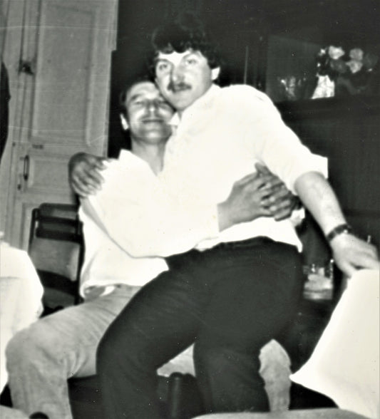 Bulgaria 1970s. Man sits in lap of another man. Gay. Arms intertwined