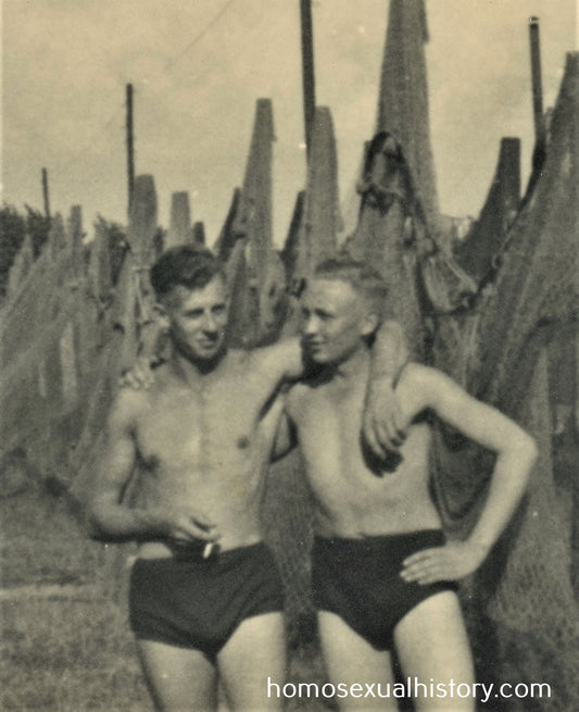 Germany - Military. 1940s WWII. Two affectionate soldiers standing together arm in arm. Shirtless