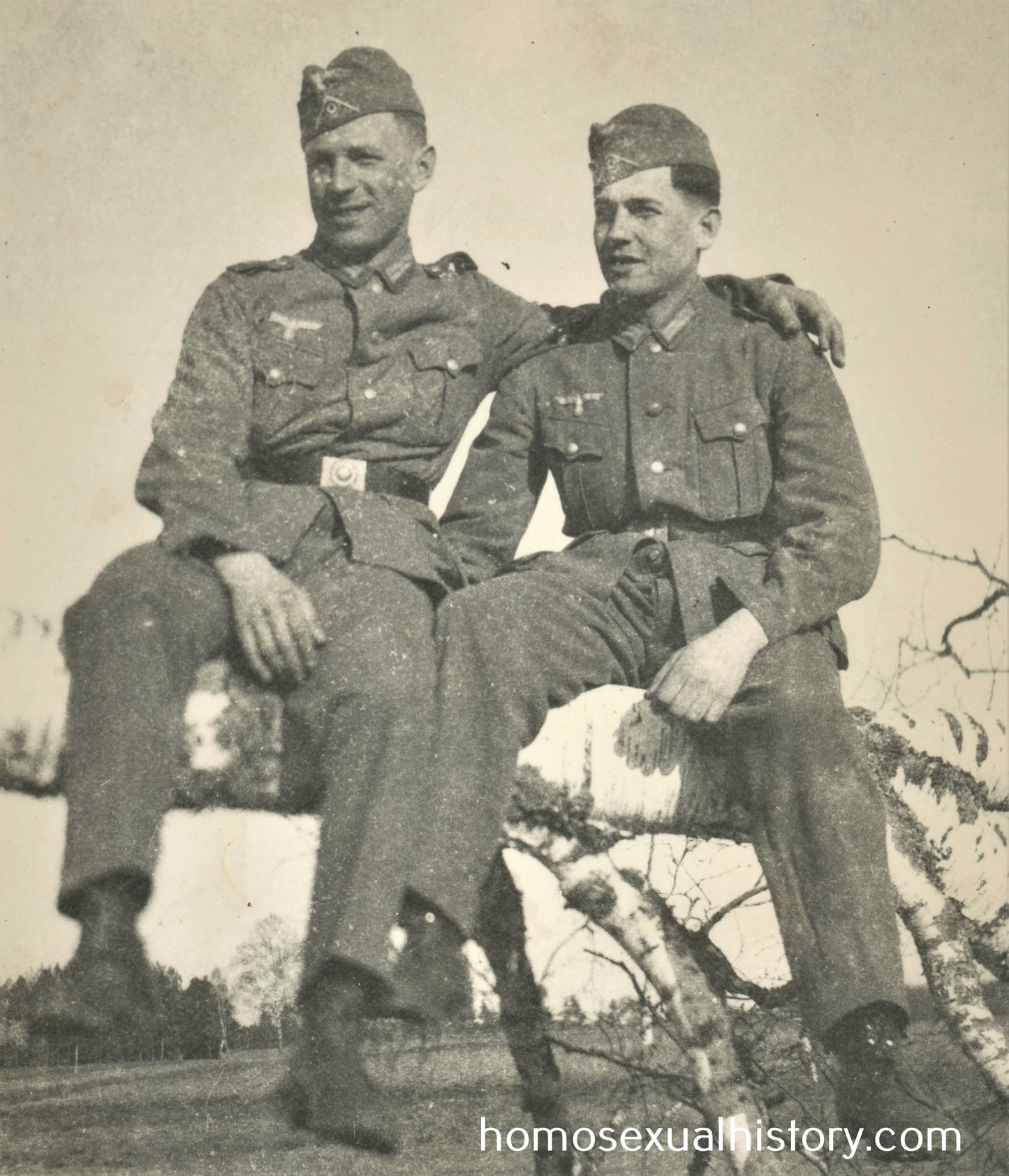 Germany - Military. 1940s WWII. Two affectionate soldiers. Arm on shoulder.