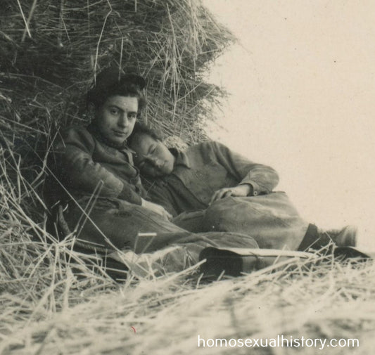 Germany - Military. 1940s WWII. Two affectionate army buddies cuddle in haystack. Gay